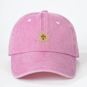 Close-up of pink washed cotton baseball cap with yellow sun embroidery details