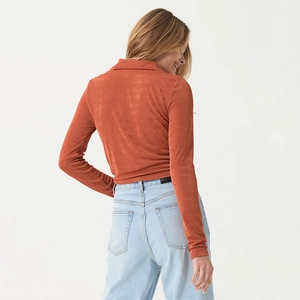 Back view detail of rust red long sleeve shirt showing slim fit and suede texture