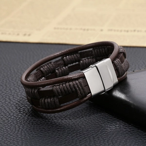 Detail of dark brown multilayer braided leather bracelet with silver magnetic clasp