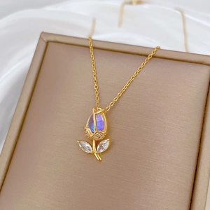 Golden tulip necklace with iridescent opal and zircon accents on a gift box display