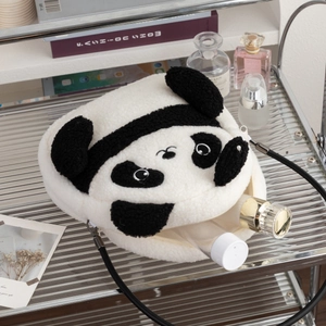 Macro view of plush panda shoulder bag showing large capacity for cosmetics and accessories