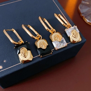 Detail view of vintage lion head earrings with rectangular black and clear zircons