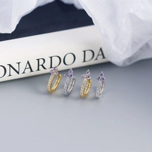 Macro shot of S925 silver flower earrings with purple zircon and white crystal pavé
