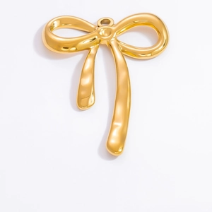 Close-up of polished 18k gold butterfly pendant with a smooth metallic finish