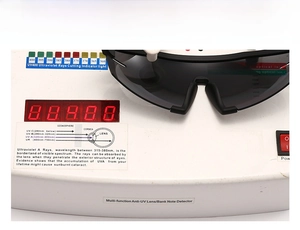 Detail view of UV400 protection test on oversized sunglasses with a professional UV detector
