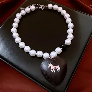 Vintage style pearl necklace with heart pendant and silver horse detail on black leather