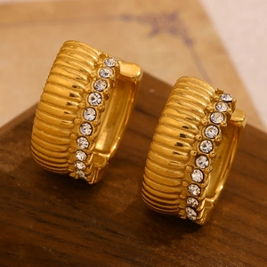Macro shot of 18K gold plated ribbed earrings with vertical zircon stone inlay detail