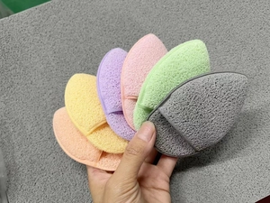 Detailed close-up of six colorful teardrop sponges for facial cleansing and makeup removal