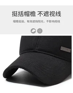 Close-up of black cotton baseball cap showing thick twill fabric and metal side buckle detail