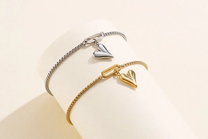 Detailed view of adjustable heart charm bracelets in gold and silver stainless steel