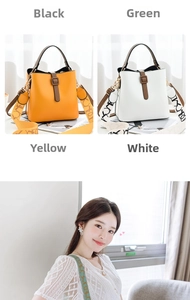 Detail of stylish bucket bag with wide contrast lettered strap and decorative buckle