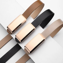Three minimalist leather belts in brown, black, and beige with golden metal buckles