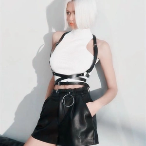 Detail of adjustable black PU leather harness with metal buckles on model