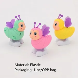 Three colorful clockwork honey bee toys in pink, green, and yellow plastic material