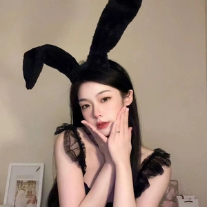 Detail showing plush black lace bunny ear headband with soft texture and floral lace trim