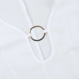 Close-up of golden metal ring detail on white V-neck knitted dress fabric texture