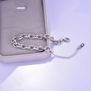Close-up of silver steel chunky link chain bracelet with lobster clasp on jewelry box