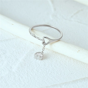 Detail of S925 sterling silver ring with dangling heart-shaped zircon pendant charm