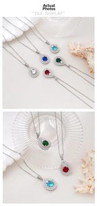 Detail view of multicolored teardrop pendants with pavé set crystals on silver chains