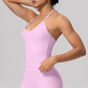 Pink halter neck yoga top with matching leggings on model, professional gym set