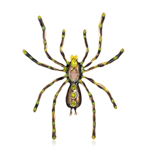 Gothic spider brooch with iridescent gemstone and green crystals on white background