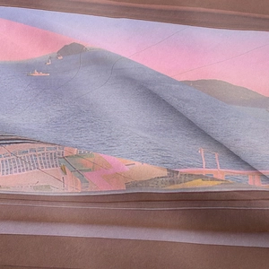 Detail shot of silk fabric texture with bohemian mountain landscape print and natural folds