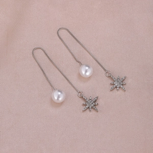 Silver drop earrings with pearl and sparkling star charm on pink silk fabric