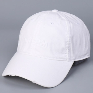 Detail of white cotton baseball cap showing distressed brim and letter embroidery