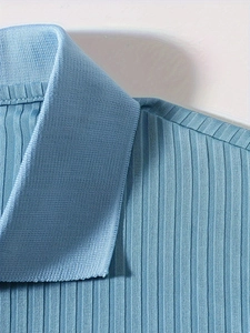 Macro shot of light blue ribbed knit texture and collar detail on men's polo shirt
