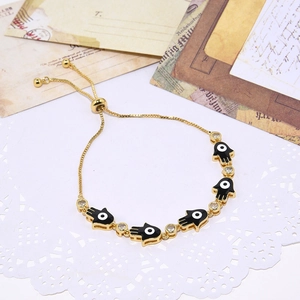 Gold Hamsa Hand bracelet with evil eye charms and clear zircon stones in vintage style