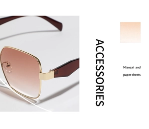 Detail of square gold metal sunglasses with brown gradient lenses and modern framing