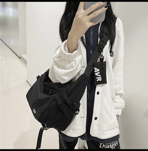Detail of black nylon crossbody bag with detachable mini pouch and side mesh pocket