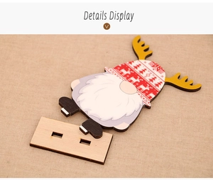 Detail display of a wooden Christmas gnome ornament with red hat and reindeer antlers