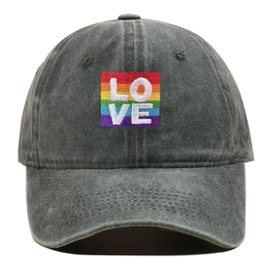Close-up detail of washed grey baseball cap with rainbow LOVE embroidered patch.