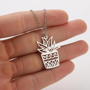 Detailed view of a silver hollow-out potted plant pendant on a fine stainless steel chain