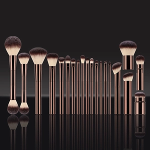 Professional makeup brush set with rose gold metal handles and dual-tone soft bristles