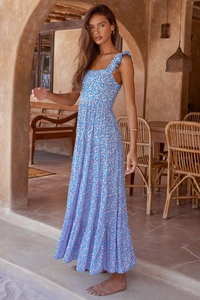 Detail of bohemian tiered maxi dress with floral print and ruffled shoulder straps