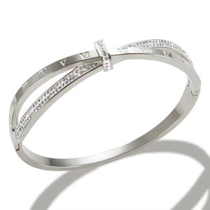 Detail view of silver titanium steel bangle with roman numerals and inlaid crystals