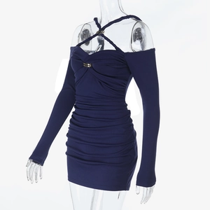 Detail of navy blue slim fit dress featuring cross halter neck and gold buckle accents