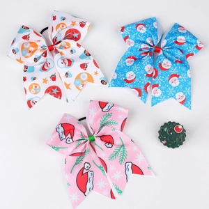 Detail of Christmas ribbon hair bows with Santa and snowflake prints on elastic bands