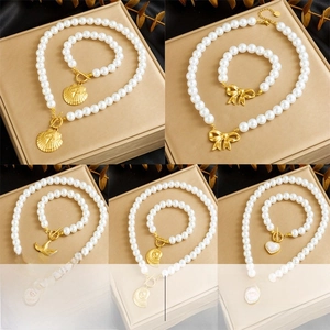 Detail of vintage gold pearl jewelry sets with seashell and starfish pendants
