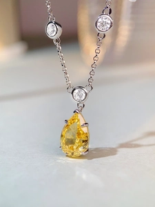 Macro shot of yellow pear-cut gemstone pendant with S925 silver bubble chain necklace
