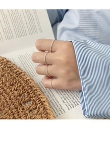 Close-up of minimalist S925 sterling silver twisted rope rings on model's hand