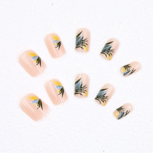 Short press-on nails with yellow and dark green ink wash plant leaves on nude pink base