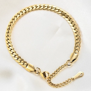 Golden 6mm Cuban link chain bracelet with lobster clasp on elegant beige silk background