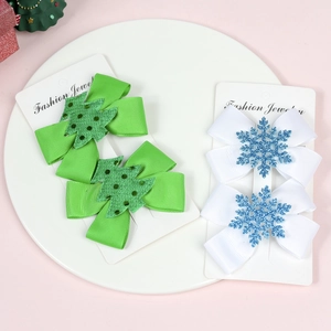 Detail of Christmas bow hair clips with glittery snowflake and tree icons for girls
