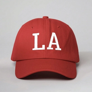 Close-up of white LA letter embroidery on premium red cotton twill baseball cap