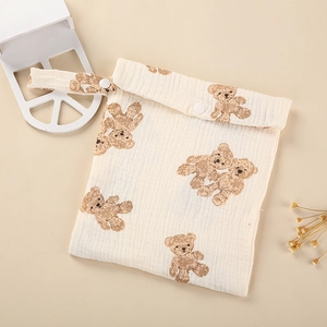 Detail of quilted cotton diaper bag with bear print and snap closure for strollers