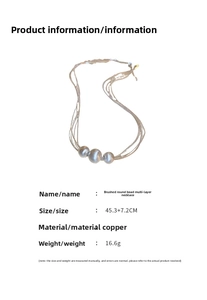 Detail of layered necklace featuring brushed metal beads and copper chain specifications