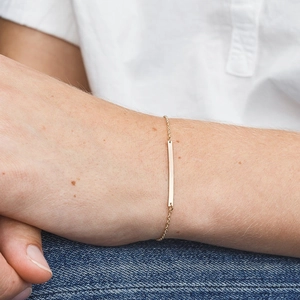 Gold rectangular pendant chain bracelet on model wrist for minimalist style look